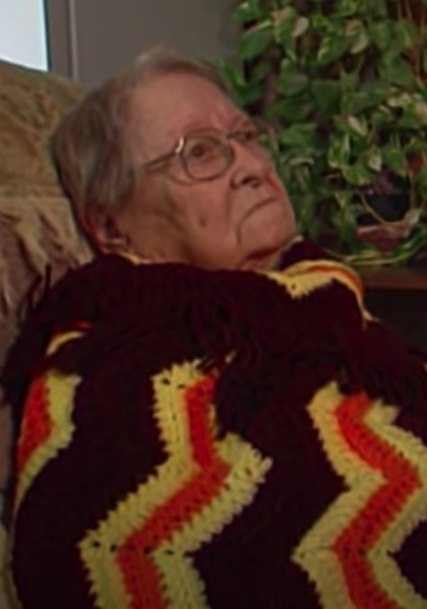 Leita Nobles sits on the couch with a crocheted blanket covering her