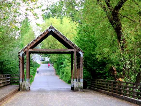 A public park with a partly covered bridge