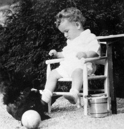 Baby Charles Lindbergh Jr. sitting in a chair in the yard